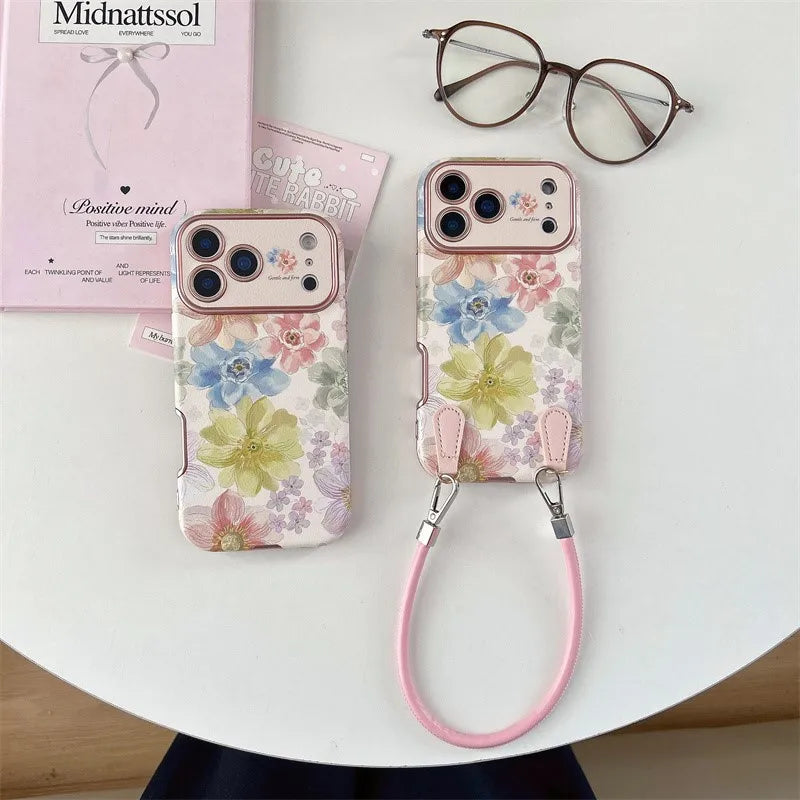 Funda iPhone Jardín Atelier con flores pintadas y correa de mano